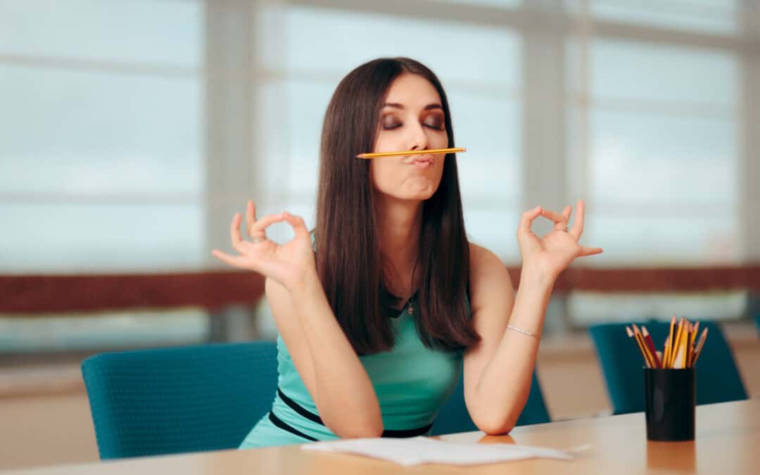 Female office worker balancing pencil on her upper lip, wondering how to unsuck the boardroom jargon